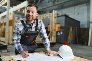 Construction of modern modular houses. An architect works with building plans