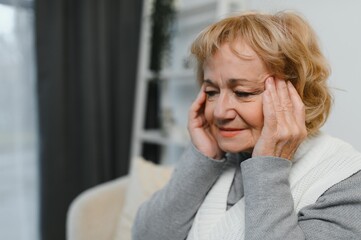 Senior woman suffering from a headache
