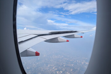 Airplane wing seen through a window