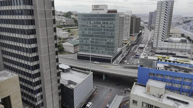 Drone flies toward skyscrapers downtown on a cloudy afternoon in Gqeberha, Port Elizabeth, South Africa