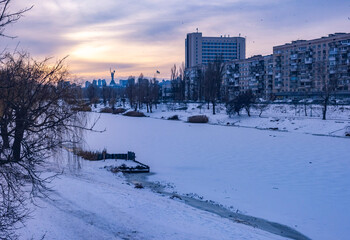 Mother Ukraine Monument watching a frozen Kyiv cityscape
