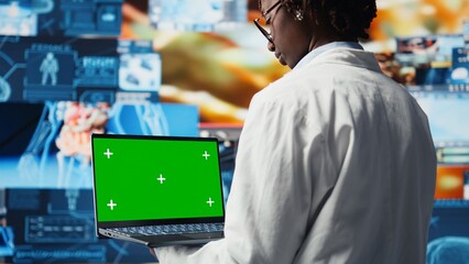 Isolated screen laptop used by healthcare researcher analyzing medical data visualizations, doing disease prevention. Chroma key notebook used by scientist doing patient scans research, camera A