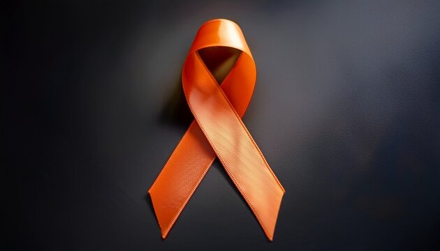 orange awareness ribbon on dark background representing support for multiple sclerosis leukemia and other related causes