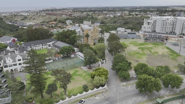 Drone flies over stadium lights on a cloudy afternoon in Gqeberha, Port Elizabeth, South Africa