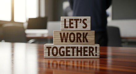 Lets Work Together Wooden Blocks on a Desk in an Office Setting.