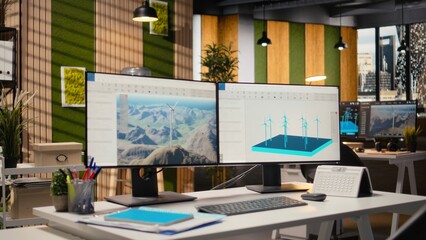 Wind turbine CAD design software used for sustainable energy research in engineering office. Software interface on PC with digital modeling of wind energy generator infrastructure
