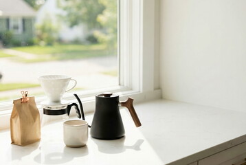 Modern pour-over coffee setup on a white kitchen counter by a window, bathed in natural morning light. Home brewing ritual.
