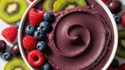 A colorful bowl of acai smoothie topped with fresh fruits
