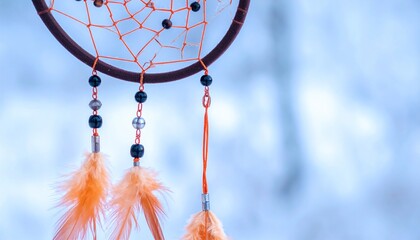Close-up of a dream catcher against a blurred, frosty background
