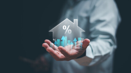 Real estate investment concept. Hand holding virtual house icon with percentage and rising graph. Property value increase, mortgage rate, housing market analysis and economic success. Interest rate.