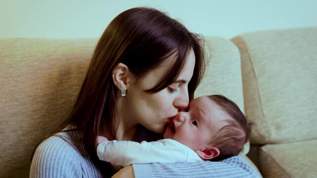 Tender mother soothing her crying newborn baby
