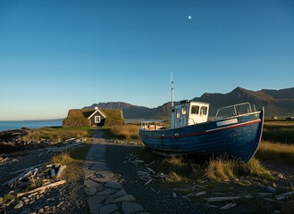 Old blue fishing boat rests near a traditional turf house on a tranquil coastal landscape with mountains and the moon visible in the clear sky.