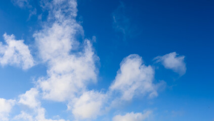 Fototapeta premium Blue sky with white cumulus clouds on a clear day, background of tranquil atmosphere and vastness