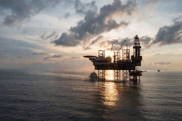 Aerial view of offshore jack up rig in a shipyard during sunset for oil and gas exploration and production.