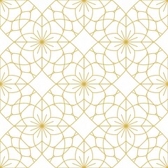 Intricate golden floral pattern on white background from overhead viewpoint