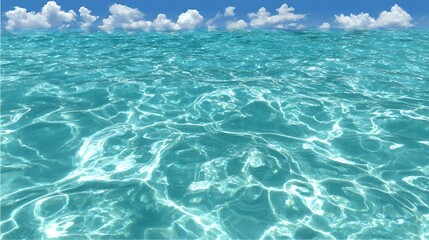 Clear blue ocean water with sunlight reflections and clouds above