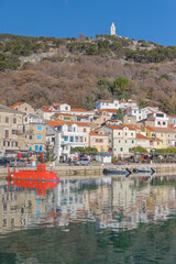 Baska harbor with red tourist submarine and boats