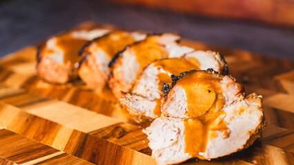 Rich gravy poured over sliced roasted pork on a wooden board. Steaming, juicy meat with glossy sauce. Perfect for food content and recipe tutorials.