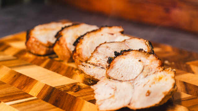 Rich gravy poured over sliced roasted pork on a wooden board. Steaming, juicy meat with glossy sauce. Perfect for food content and recipe tutorials.