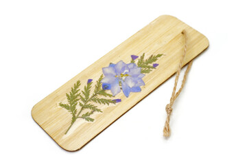Handmade Bamboo Bookmark with Pressed Flowers isolate on white background. DIY bookmark