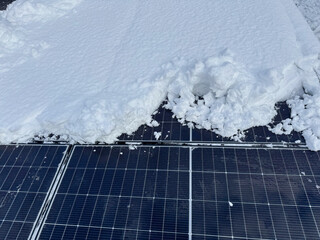 CLOSE UP: Cleaning thick snow blanket from the collectors of a home solar power plant. The challenges of maintaining solar panels and ensuring uninterrupted electricity supply in cold winter season.