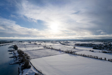 River IJssel floodplains flood land area opposite Dutch tower town Zutphen in the Netherlands De Hoven neighbourhood in the background. Graphic painterly patchwork picturesque winter wonderland