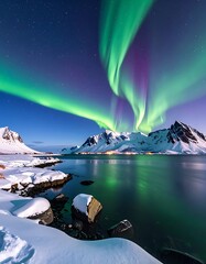 Vivid aurora borealis dancing over snow-capped mountains reflecting in the calm waters of a northern bay