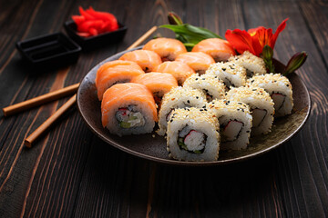 Sushi rolls assortment wooden background