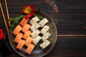 Sushi rolls assortment wooden background