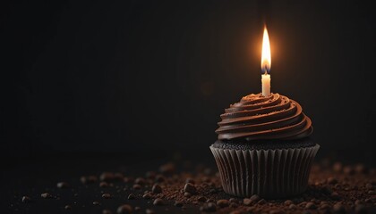 Decadent chocolate cupcake with a lit birthday candle in a dark setting