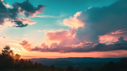Vibrant sunset sky with pink, blue, and orange clouds over a mountain range.