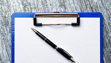 Black Pen on Clipboard with Blank Paper