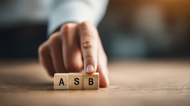 Fingers point on word ASB, Business Concept, Acronym, Abbreviations. Wooden cubes with letters on the table