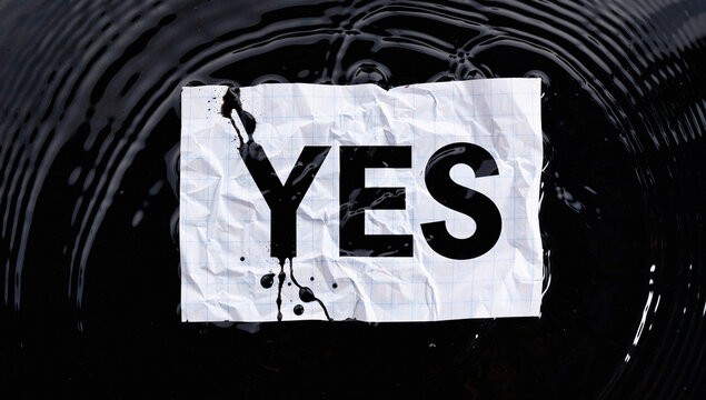 Close-up of "Yes" Sign with Water Ripples and Ink Blotches - Powered by Adobe