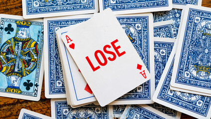 Playing Cards with "Lose" Written on Ace of Hearts