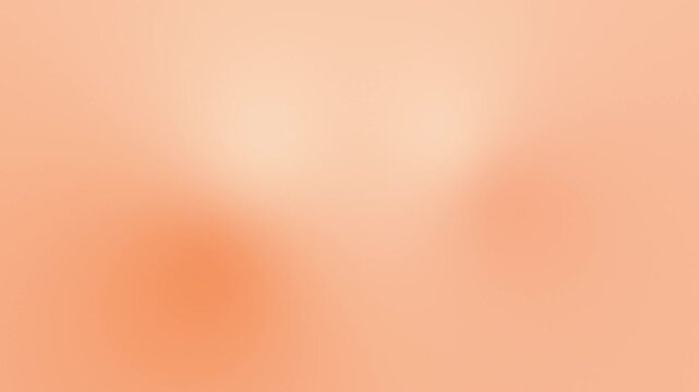 Soft peach colored abstract blurred background with gradient effect.