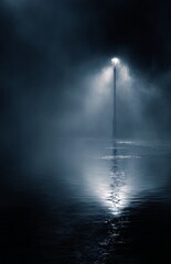 Foggy Streetlight Reflecting on Water at Night.