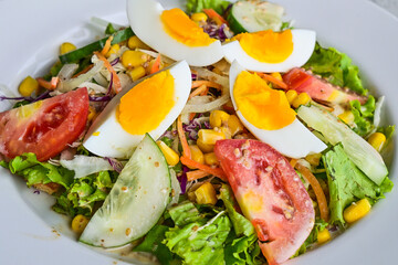 Extreme close up view of egg salad on the white plate. cruttong. mix salad. boiled egg. dressing. vegetables. high angle, above, flat lay. background. healthy. freshness.