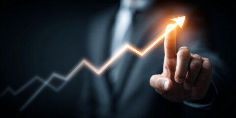 Business professional pointing at upward growth graph with glowing effect, symbolizing success, achievement, progress, and innovation in corporate sector