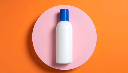 Elegant white bottle with blue cap placed on a pastel pink circle, shot from above on an orange background, perfect for cosmetic branding and product mockup use.