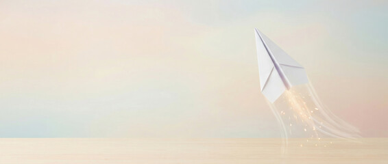 A paper airplane soars, leaving sparkles behind, created AI