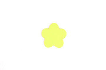 A single, soft peach-yellow flower shape, cut from paper isolated on a white background. DIY projects, stationery design, wedding and greeting card. Top view, flat lay