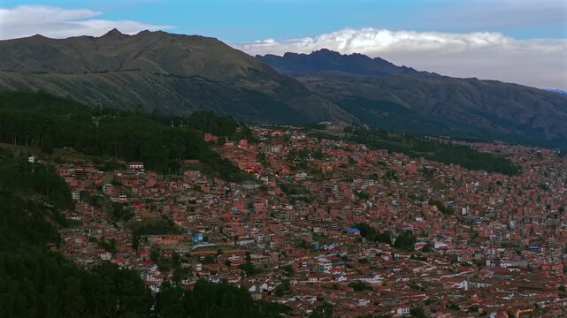 Cusco Plaza de Armas vive en Peru Per&uacute; aerial drone Cuzco Saqsaywaman cityscape red buildings Peruvian Andes landscape rainy season sunset blue sky could Inca Empire capitol parallax circle right