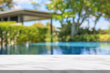 Empty marble table top with blur outdoor swimming pool in tropical resort hotel summer background