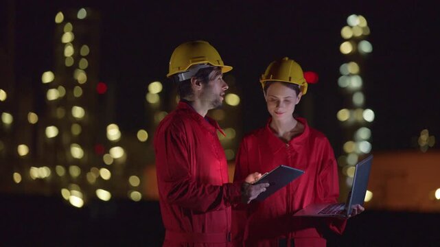 Engineers team night shift working oil and gas refinery service, Workers hard work at night petroleum industry plant background.