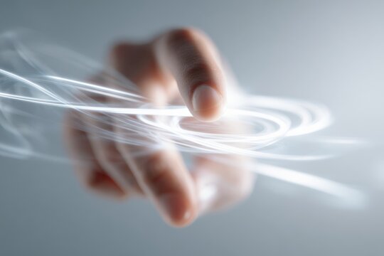 Subtle human hand gesture influencing surrounding abstract light formations.