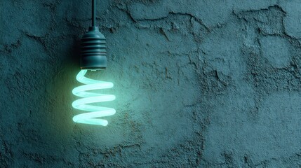 Illuminated, spiraling CFL bulb hangs against a textured gray wall, glowing with a cool, serene teal light