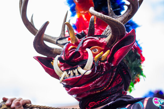 Diablada devil mask with horns and tusks during pillaro carnival