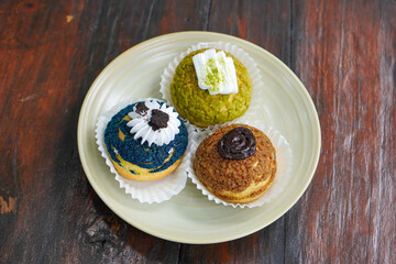 Sweet assorted pastries with colorful cream puffs, soft airy texture, creamy rich filling, and delightful dessert flavor, modern caf&eacute; style presentation with inviting visuals and appetizing charm