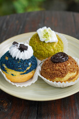 Sweet assorted pastries with colorful cream puffs, soft airy texture, creamy rich filling, and delightful dessert flavor, modern caf&eacute; style presentation with inviting visuals and appetizing charm